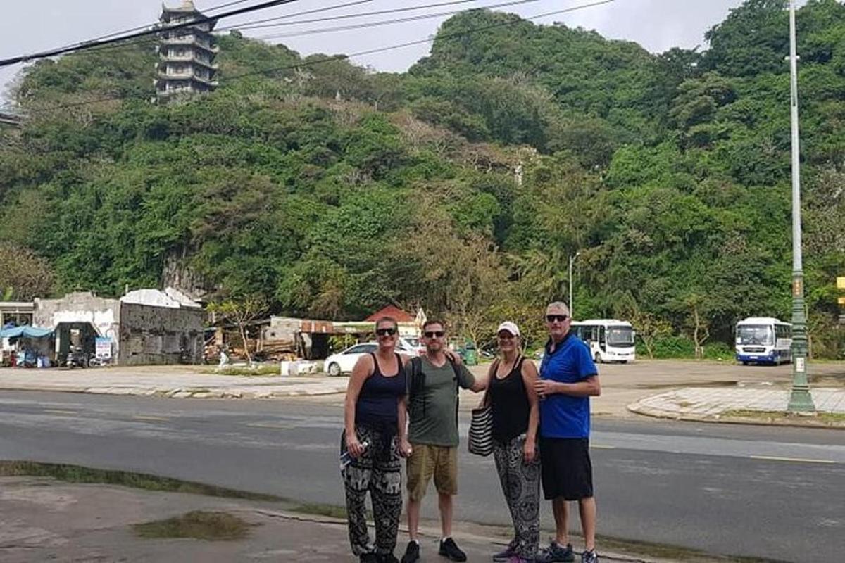 Un grupo de personas de pie al costado de una calle