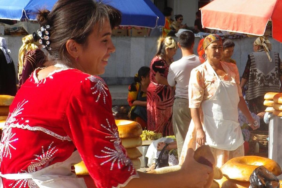 a woman in a red dress holding a plate of bread