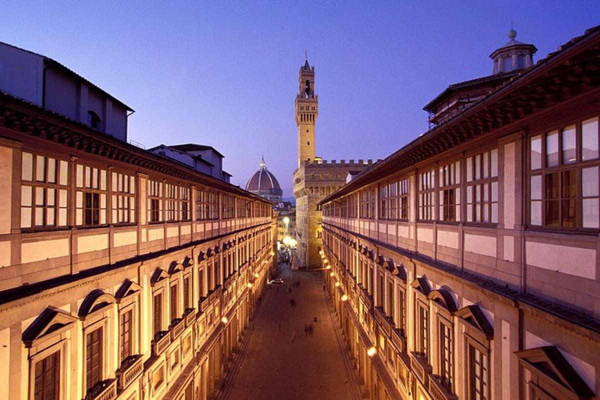 a view of a street between two buildings with a clock tower
