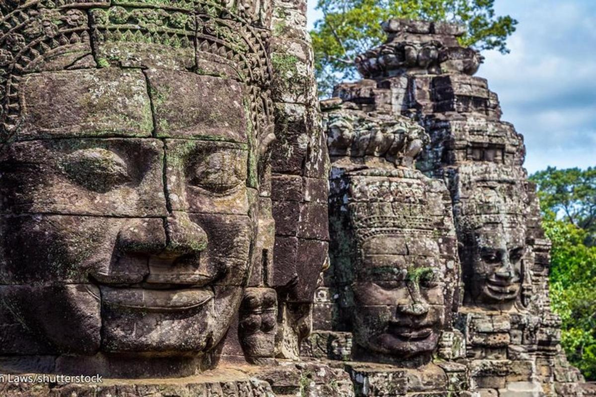 a group of stone faces on the side of a building