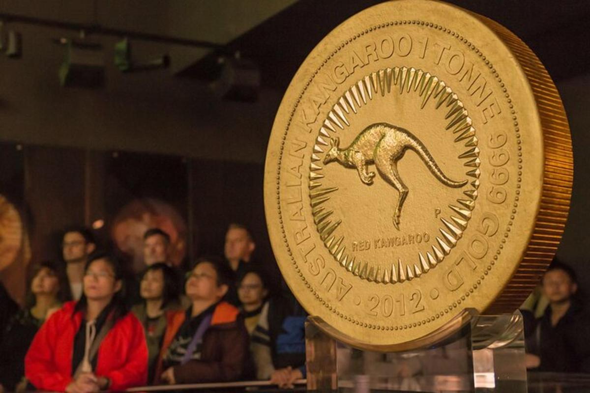 a gold coin with a horse on it in front of a crowd