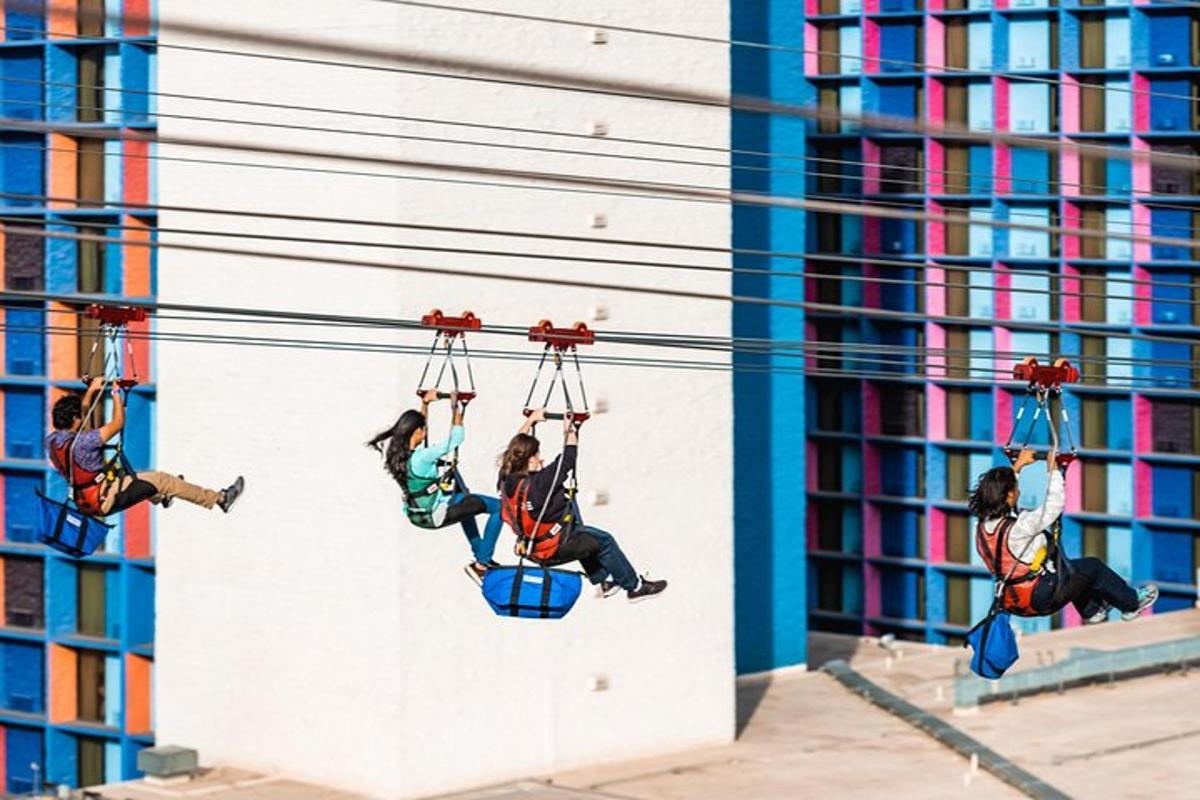 a group of girls riding on a zip line