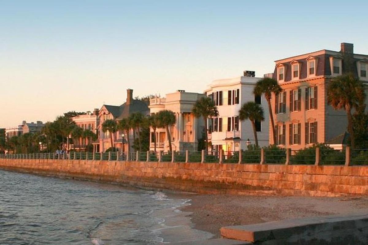 a row of buildings next to a river with houses