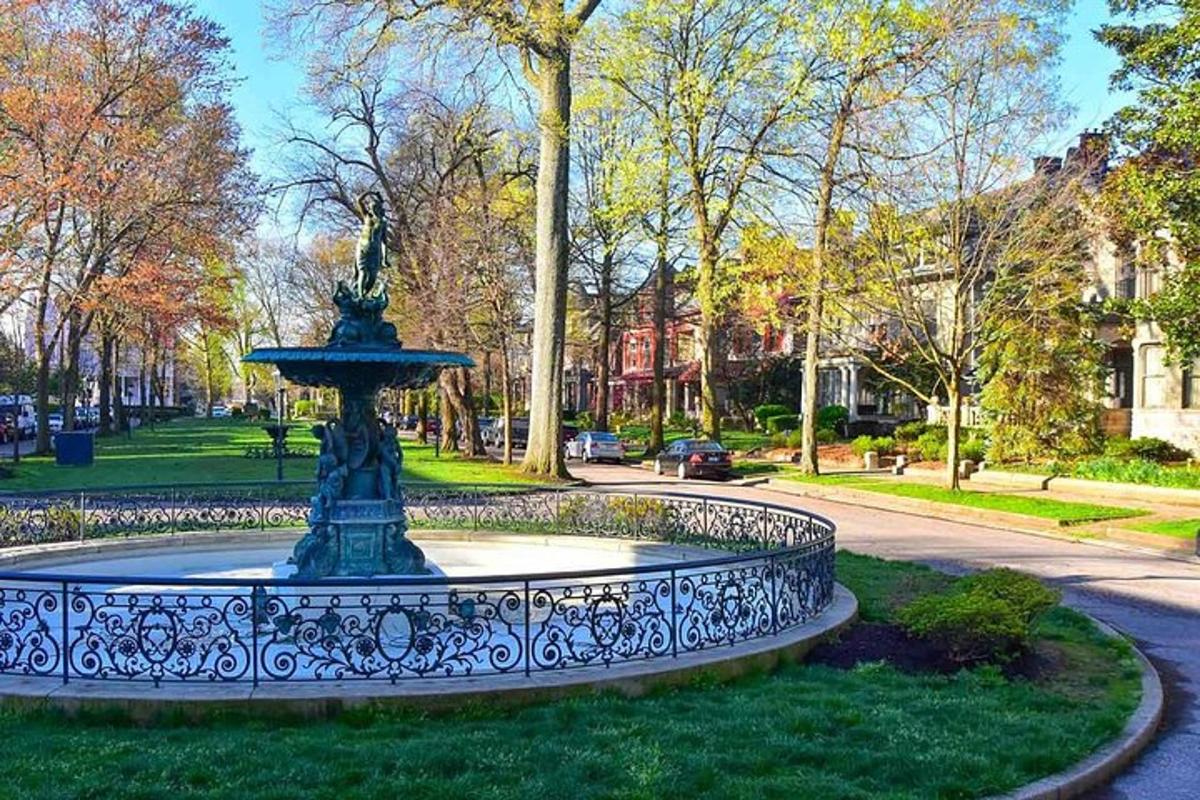 a fountain in the grass in a park