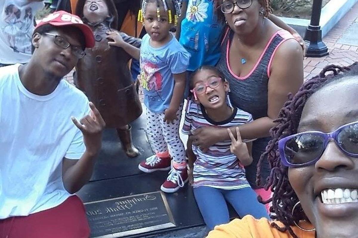 a group of people standing in front of a statue