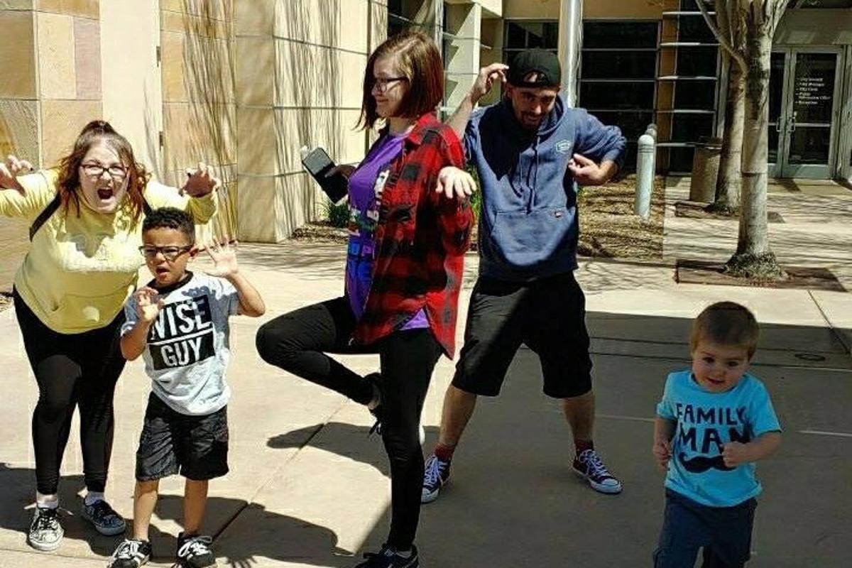 a group of people standing on a sidewalk