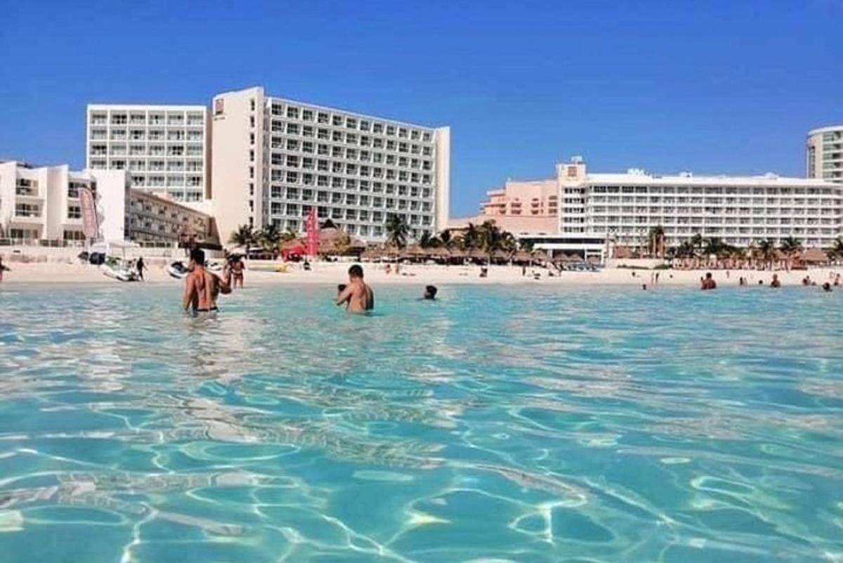 een groep mensen in het water op een strand