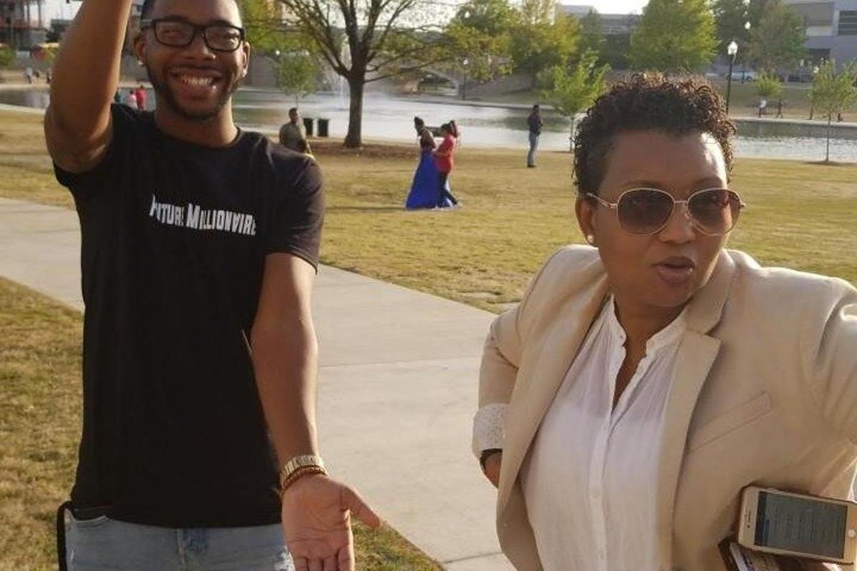 a man standing next to a woman in a park