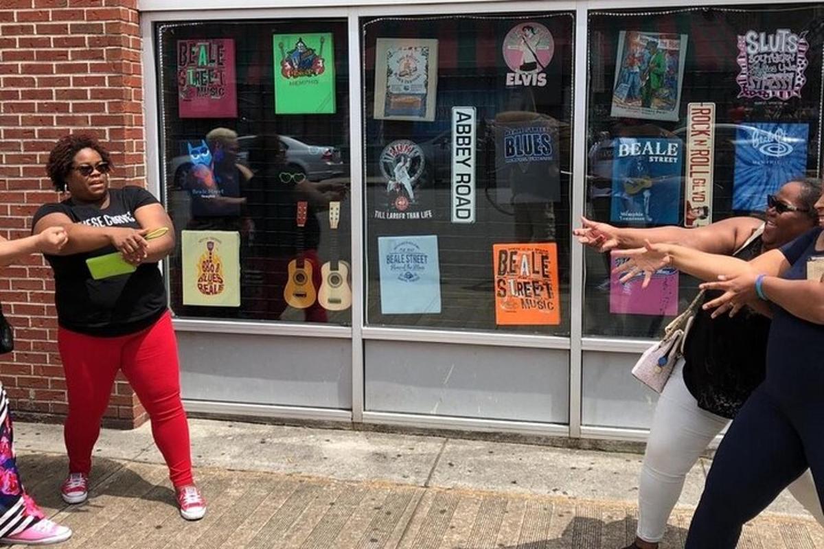a group of people dancing in front of a store