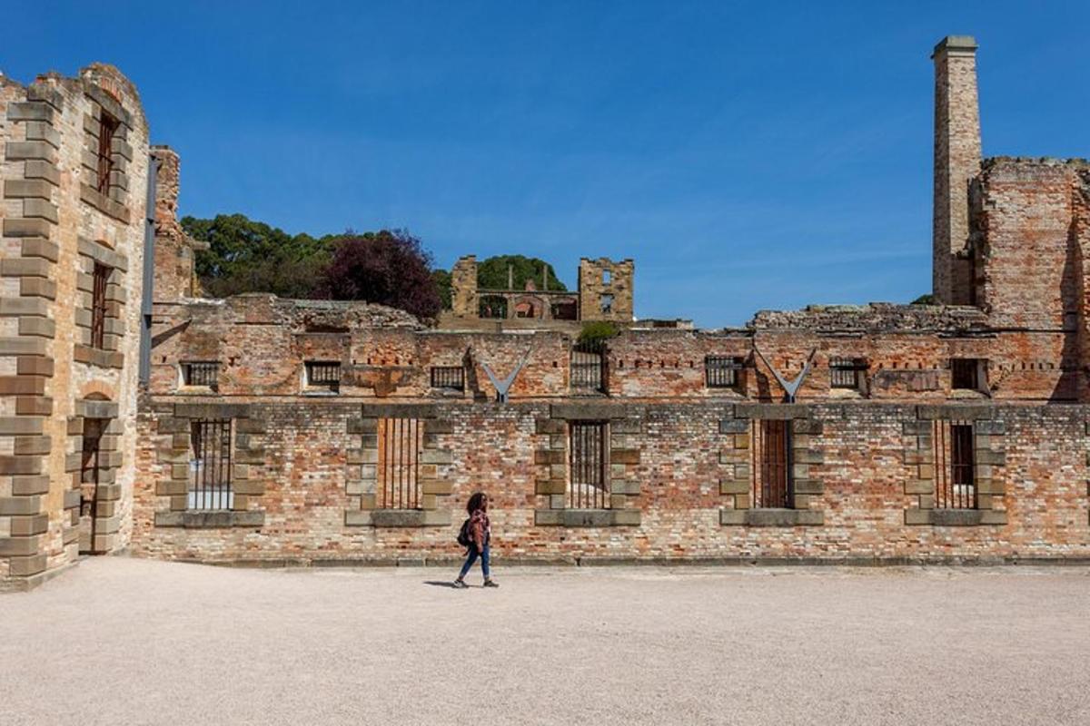 a woman walking in front of a brick building