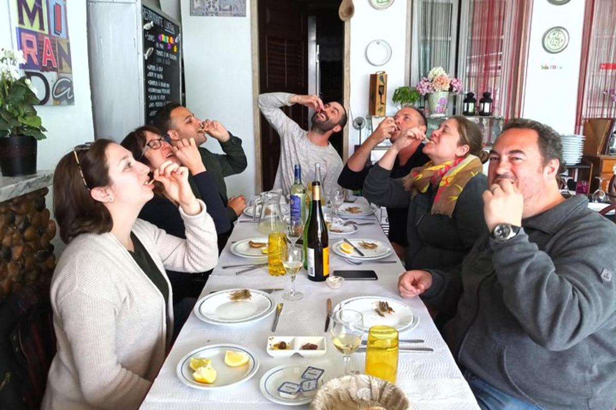 a group of people sitting at a table eating