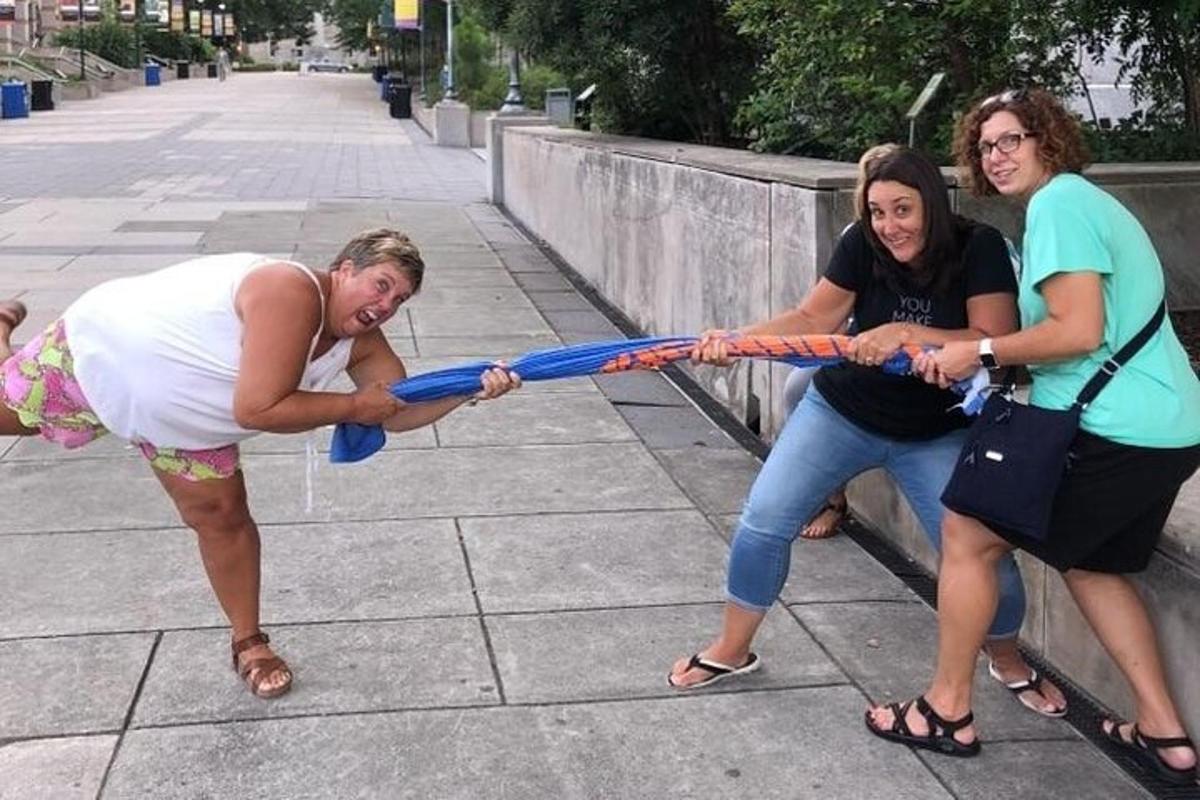 three women playing with a rope in the street