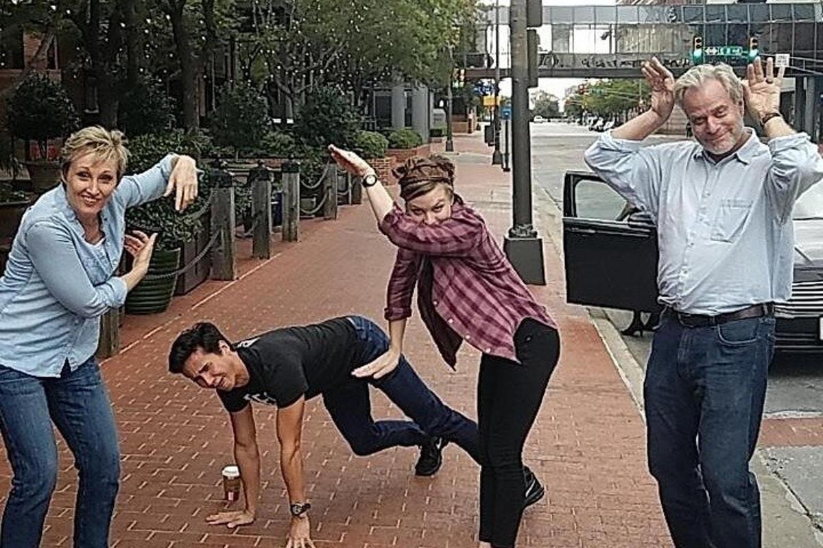 a group of people dancing on a sidewalk