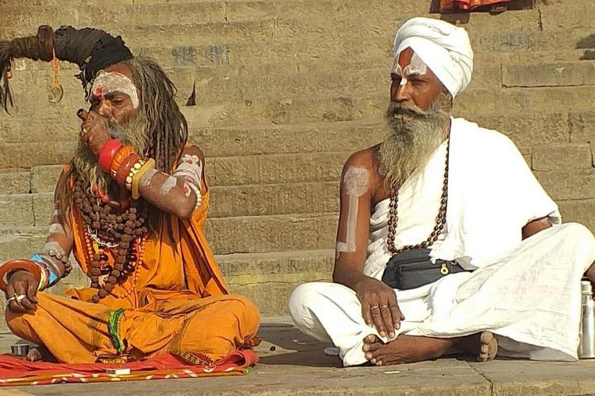 two men sitting next to each other on steps