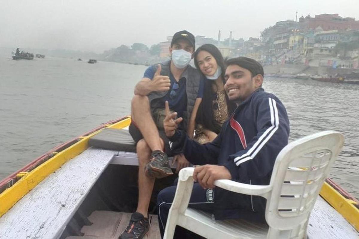 a group of three people sitting in a boat