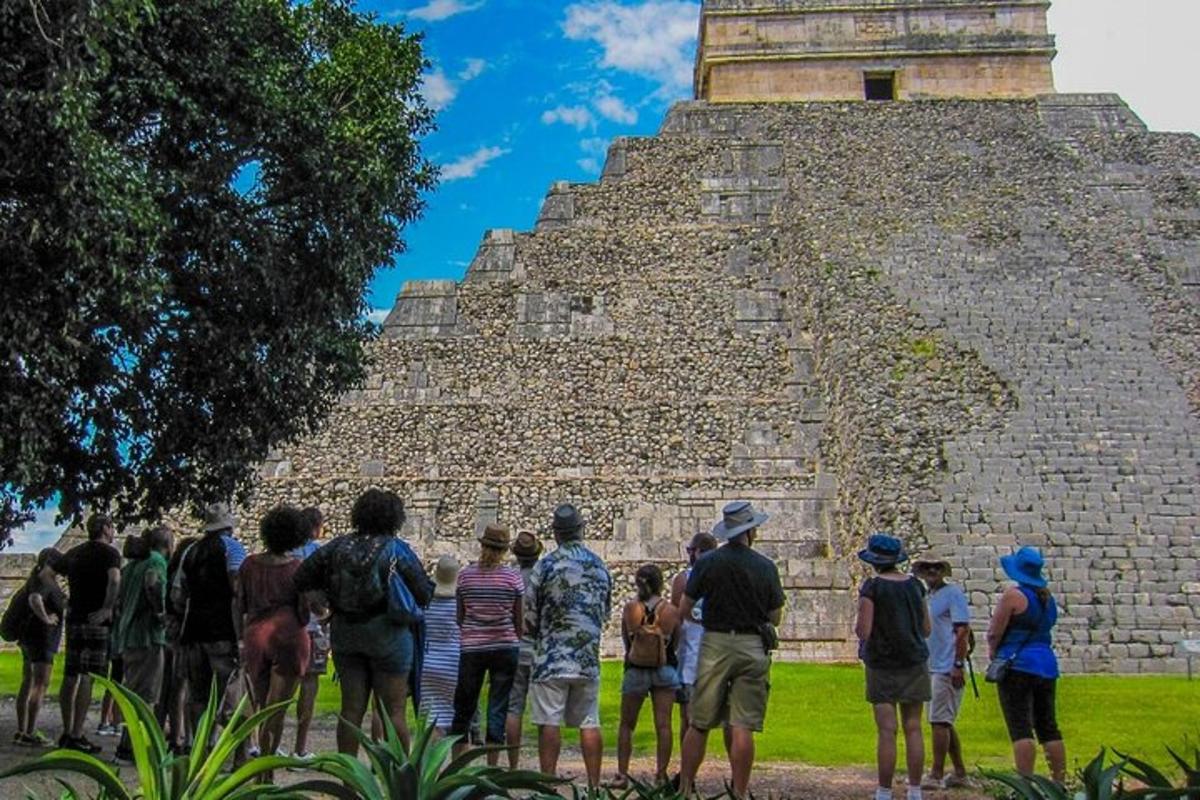 a group of people standing in front of a pyramid