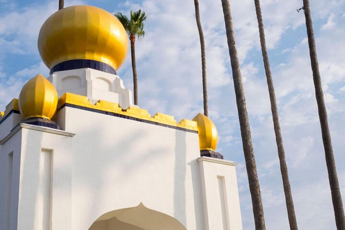 a mosque with palm trees in the background