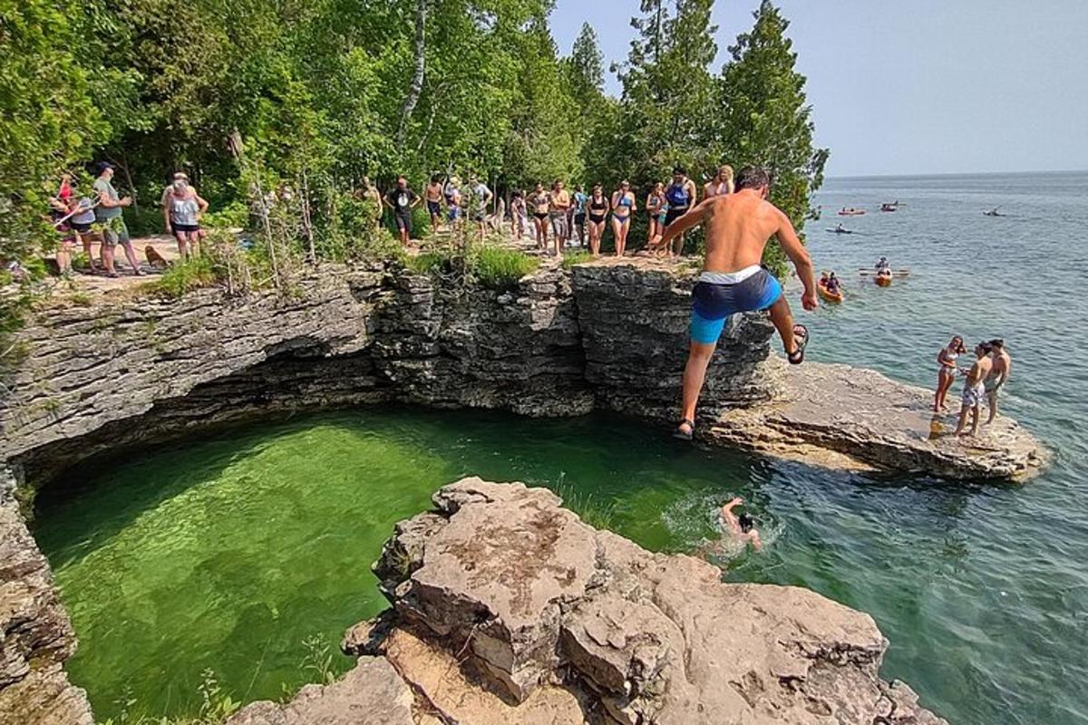 a man standing on a rock in a body of water