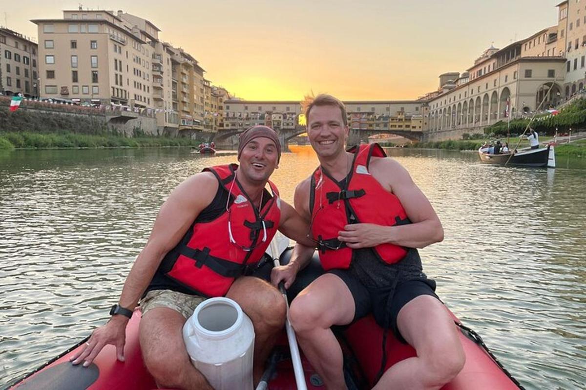 two men in life jackets in a boat on a river