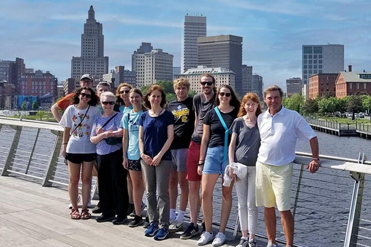 a group of people standing on a pier near the water