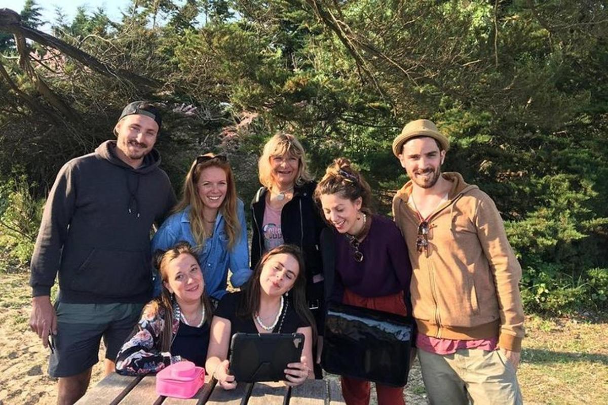 a family posing for a picture on a picnic table