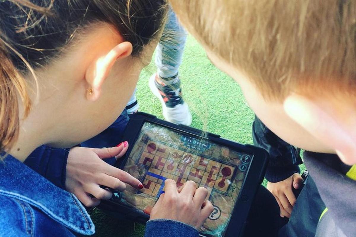 two children playing a game on a tablet computer