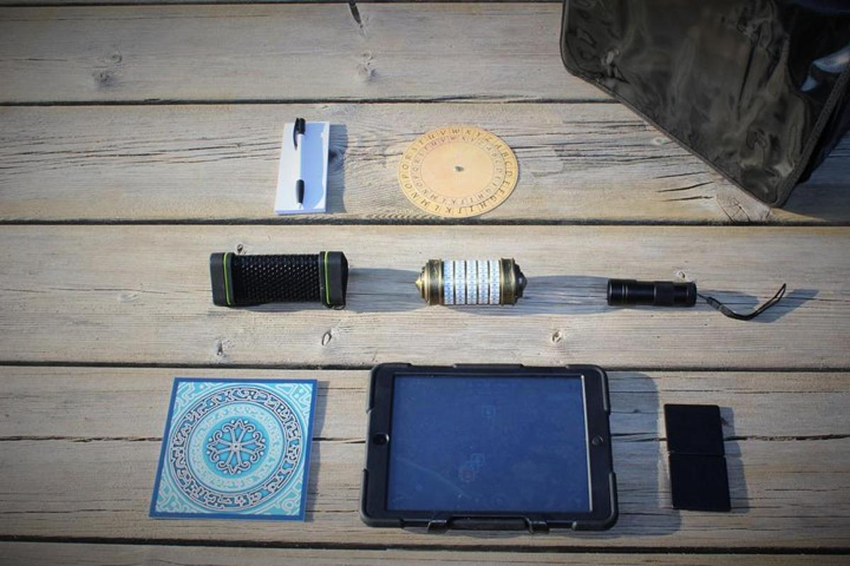 a cell phone and a lighter on a wooden floor