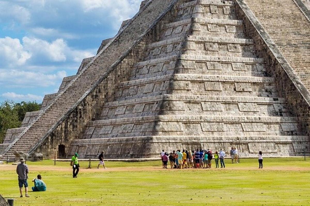 a group of people standing in front of a pyramid