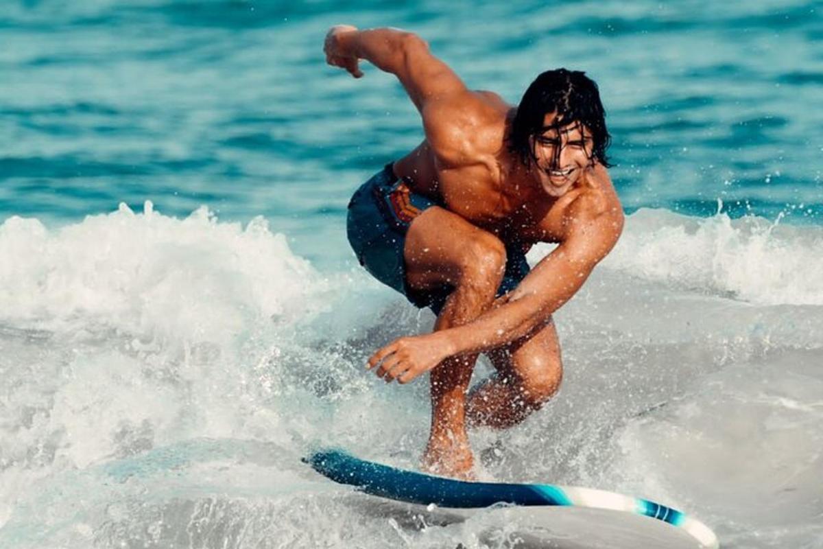 a man riding a wave on a surfboard in the ocean