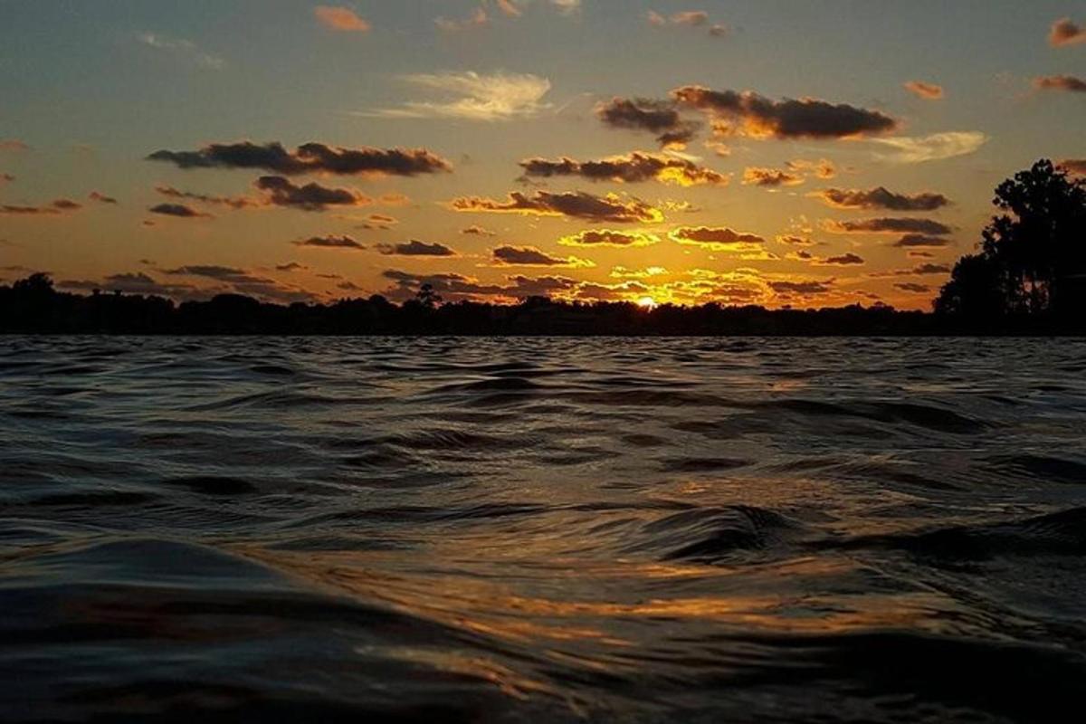 a sunset on a body of water with the sun setting