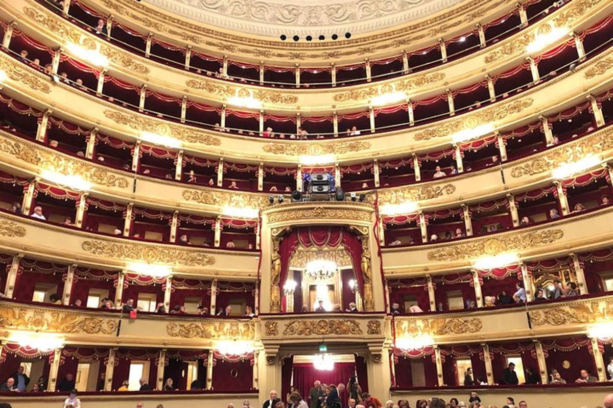 un grande auditorium di un teatro con persone al suo interno