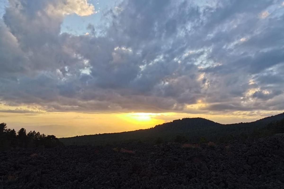 a sunset in the mountains with the sun setting