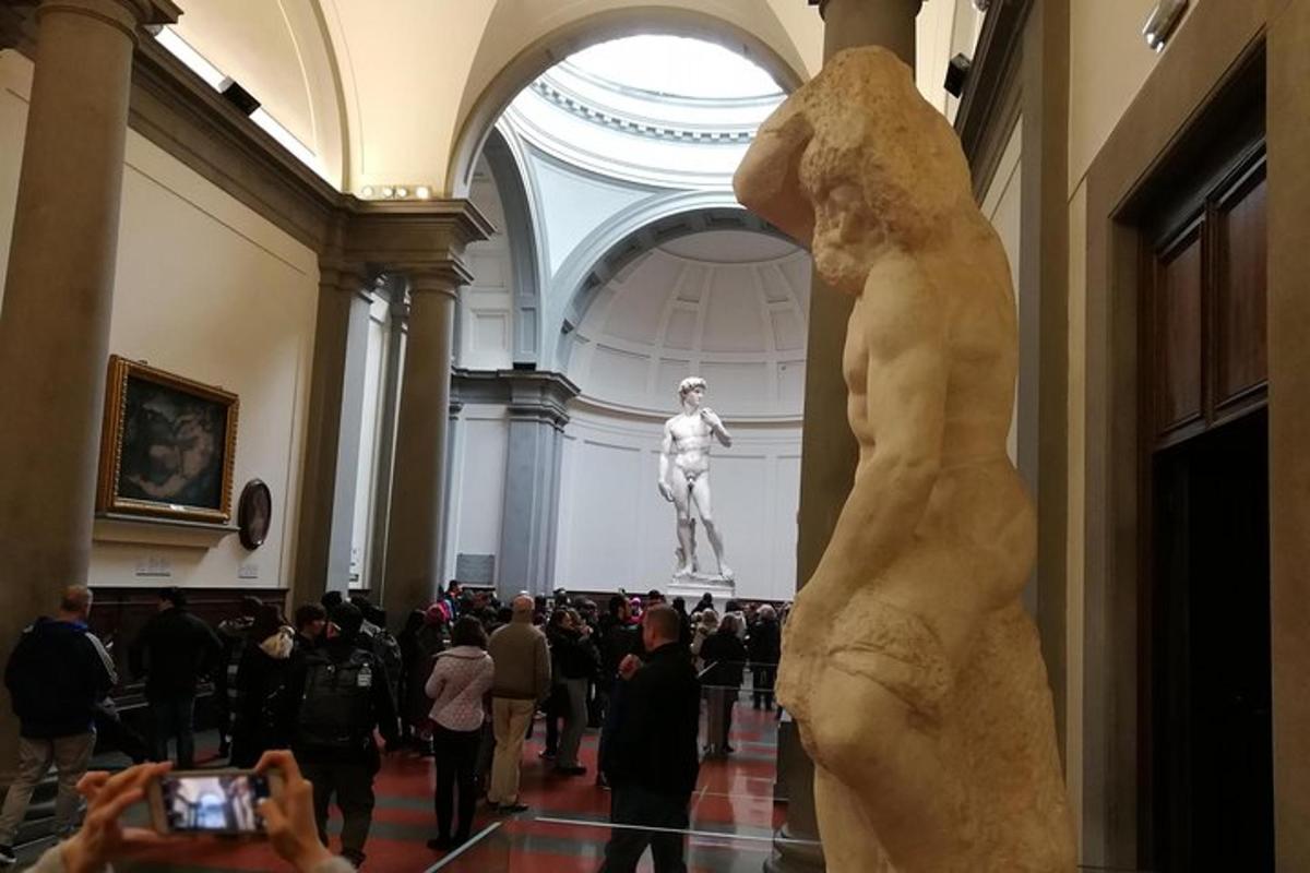 en person som tar et bilde av en statue i et museum
