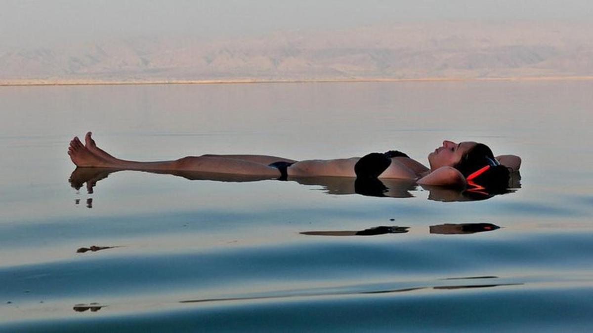a woman laying in the water in the water