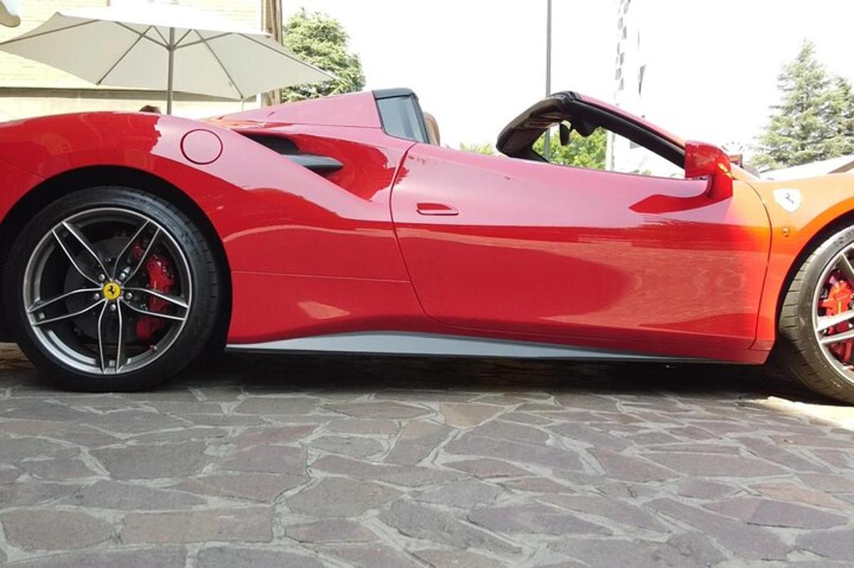 a red sports car parked on a stone road