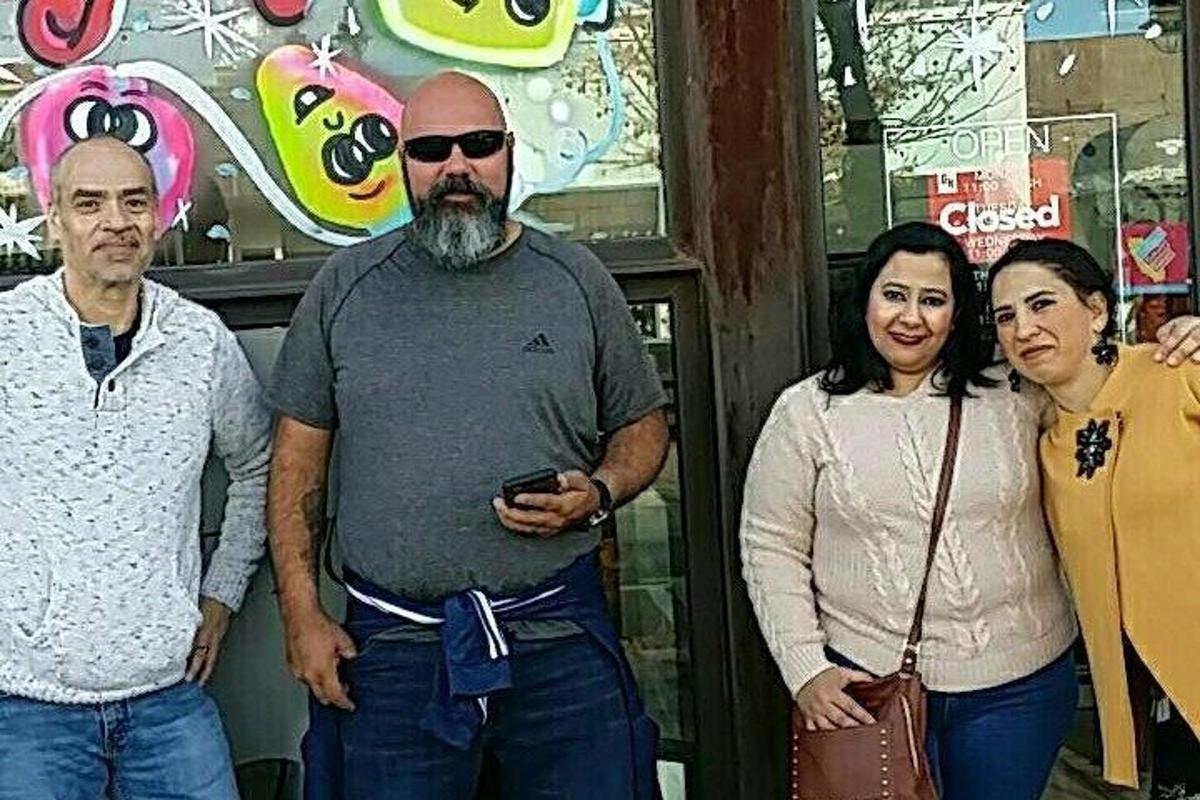 a group of people standing in front of a store