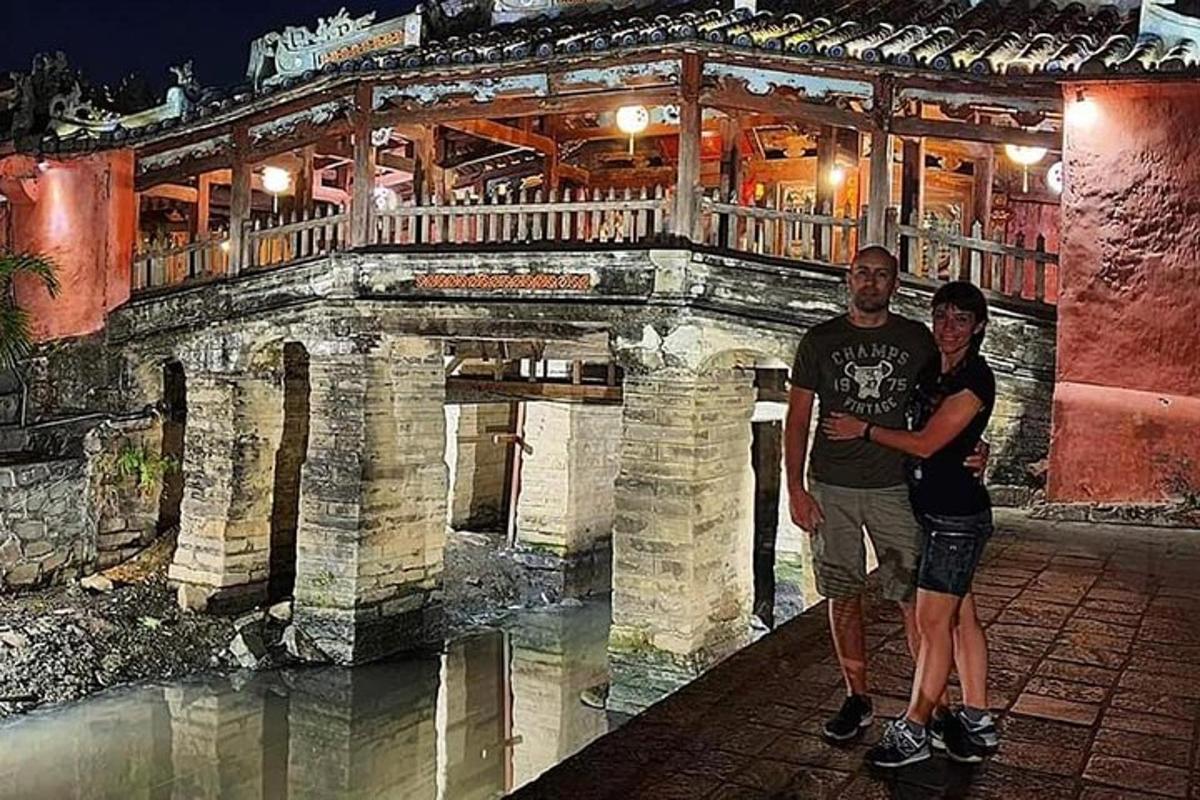 due uomini in piedi davanti a un ponte di pietra