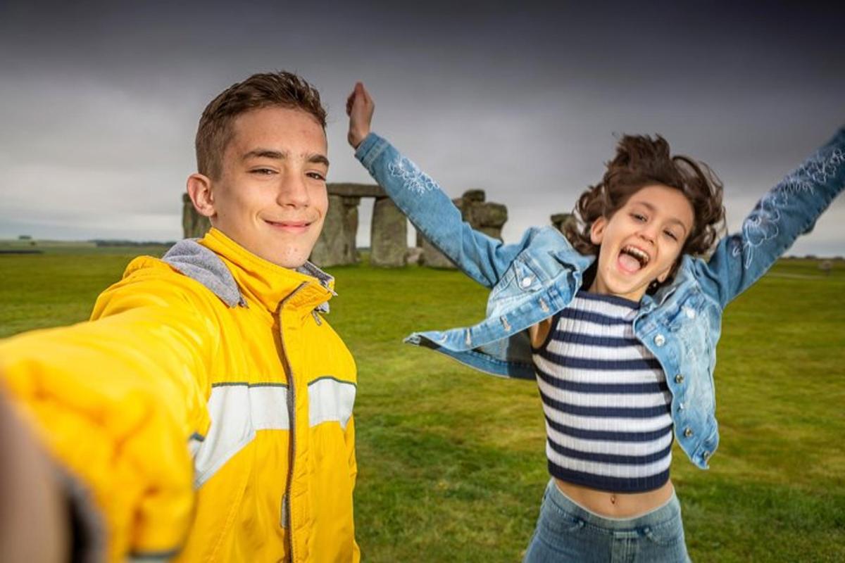 a man and a woman jumping in a field