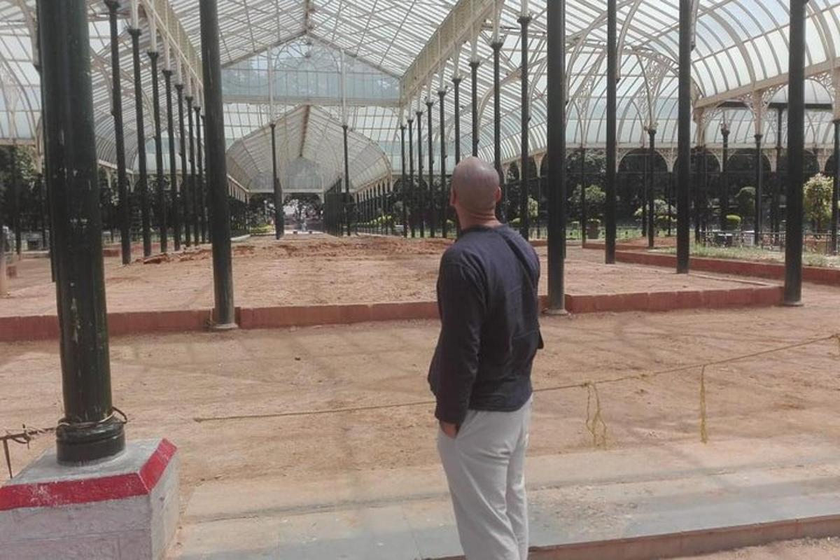 a man standing in front of a large building