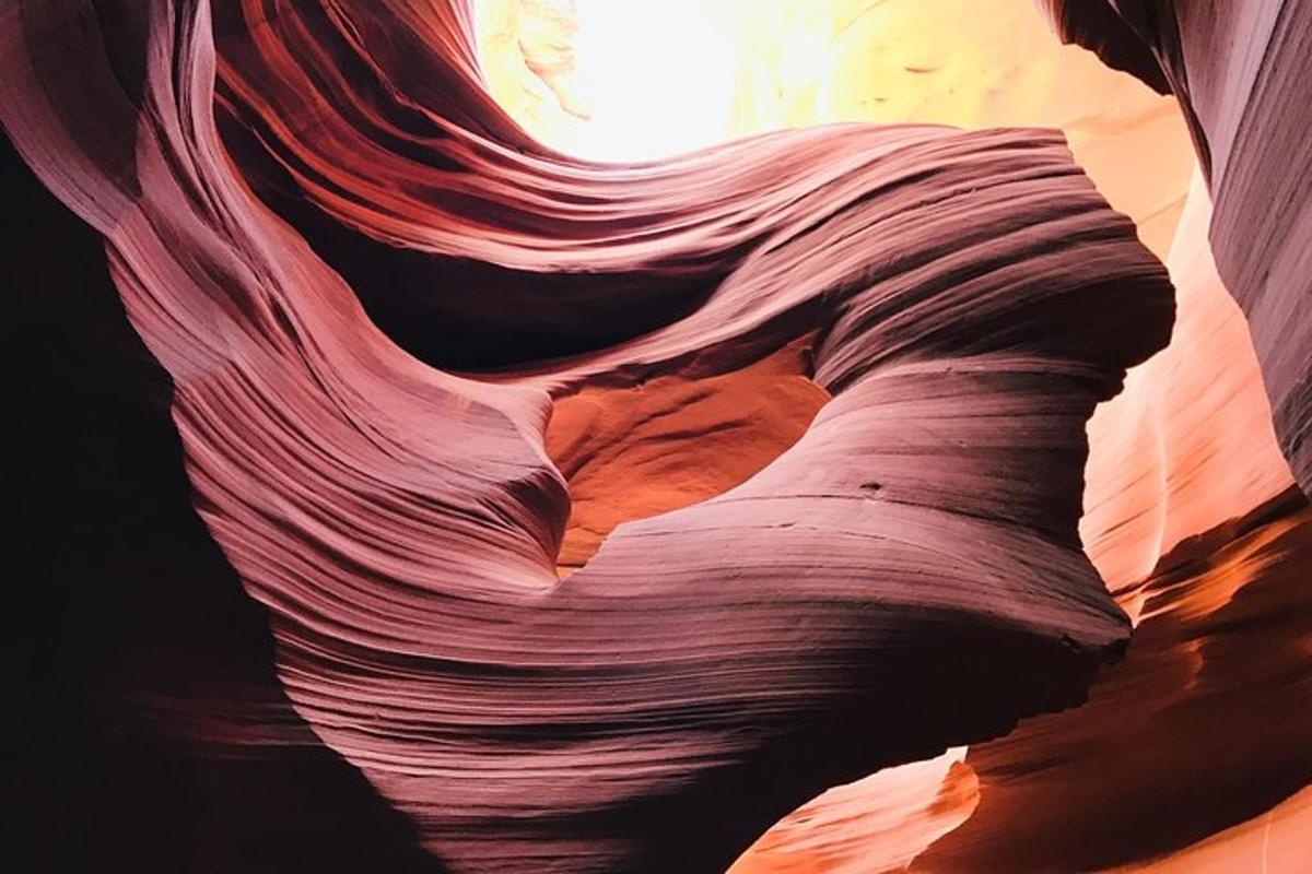 a rock formation in a canyon with the sun