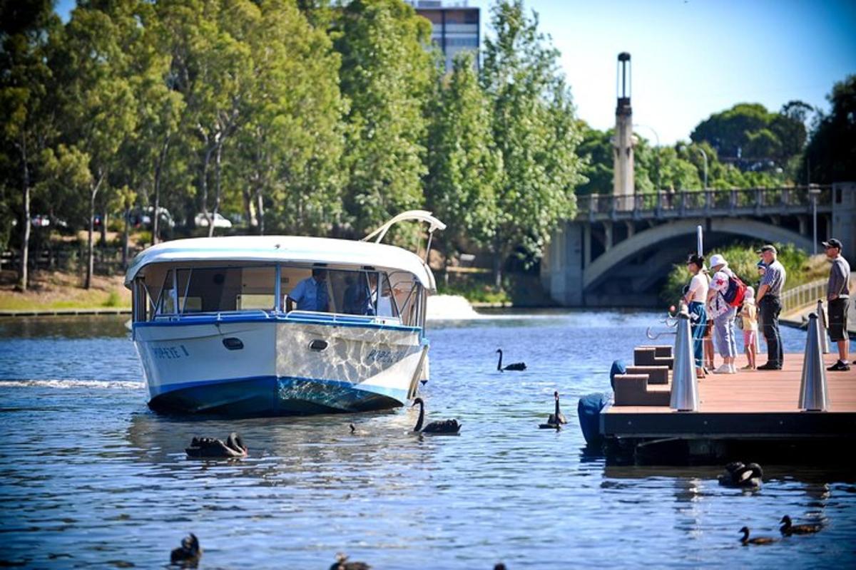 a boat docked at a dock with ducks on the water