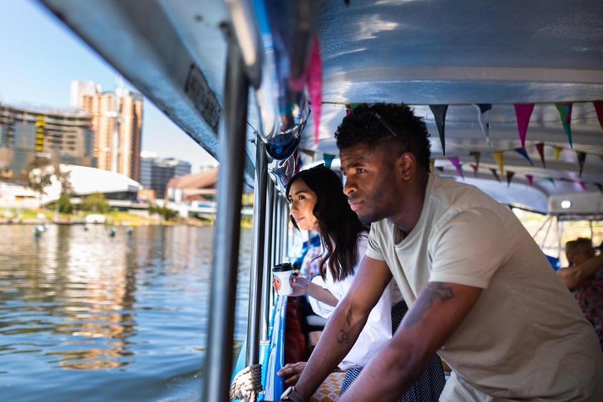 a man and woman sitting on a boat in the water