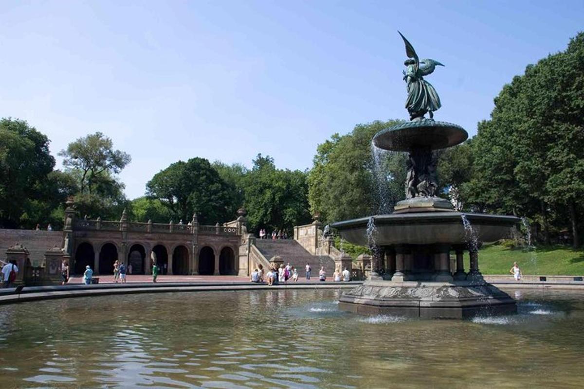 a fountain with a statue in the middle of a pond