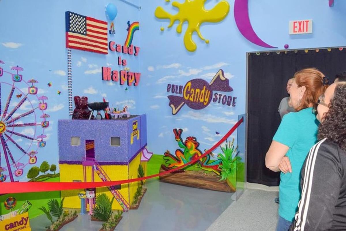 a group of people standing in front of a room with a pirate themed wall