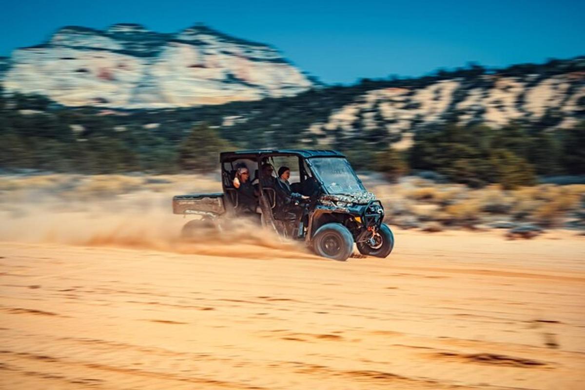 a jeep driving on a dirt road in the desert