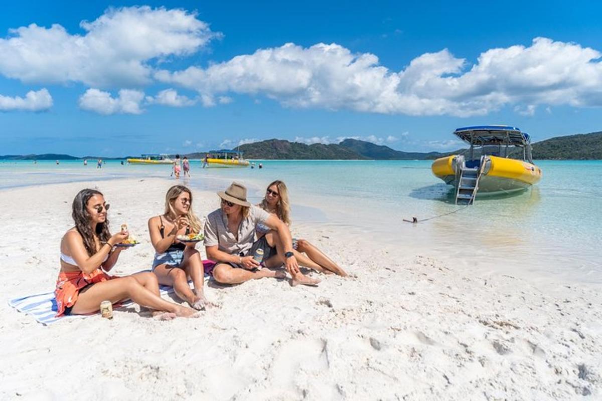a group of people sitting on a beach