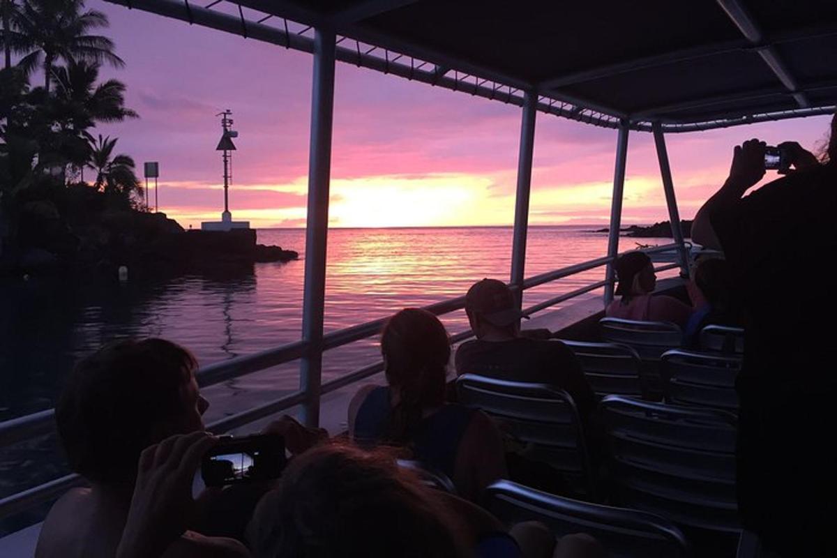 a group of people taking pictures of the sunset on a boat