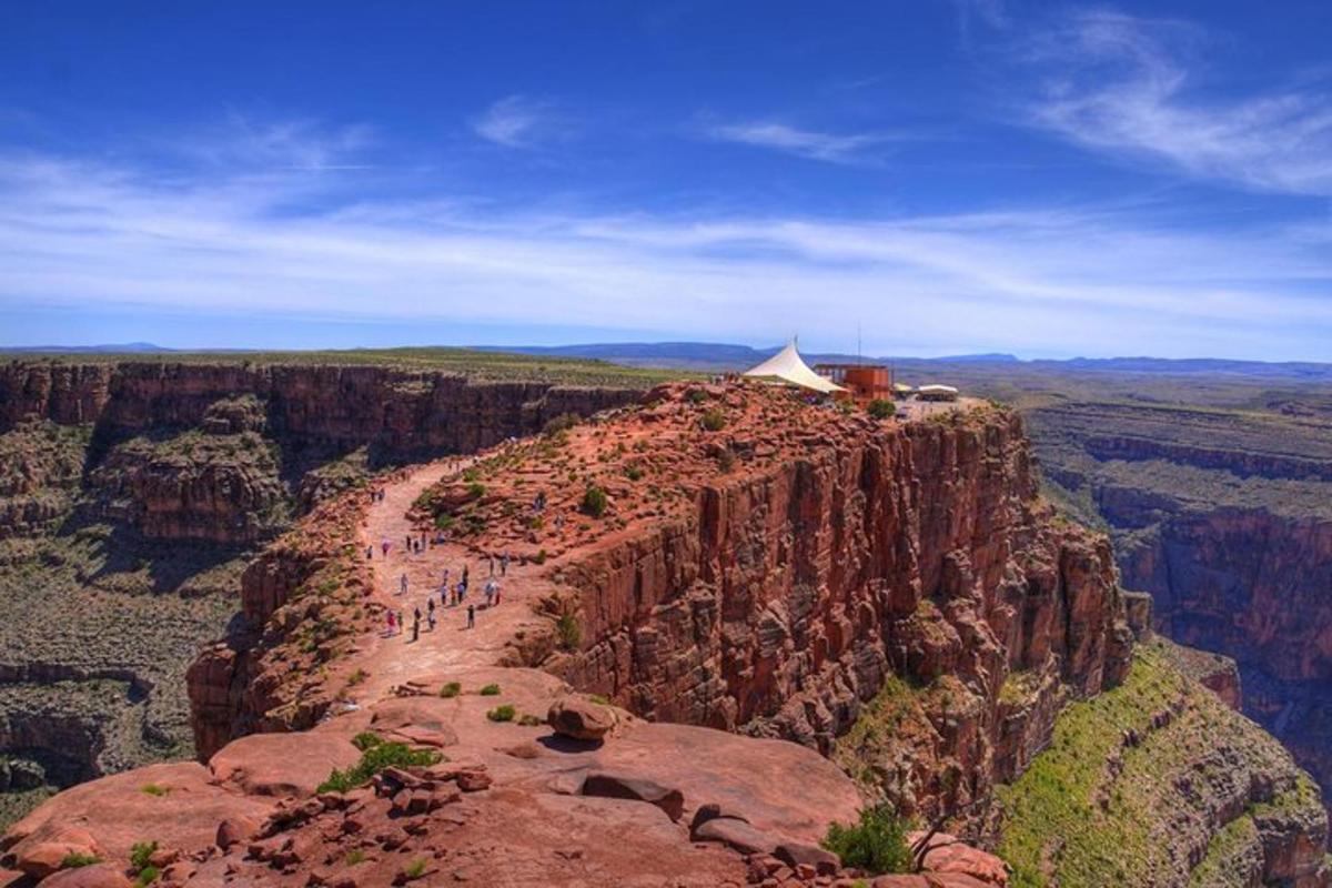 a group of people standing on the edge of a canyon