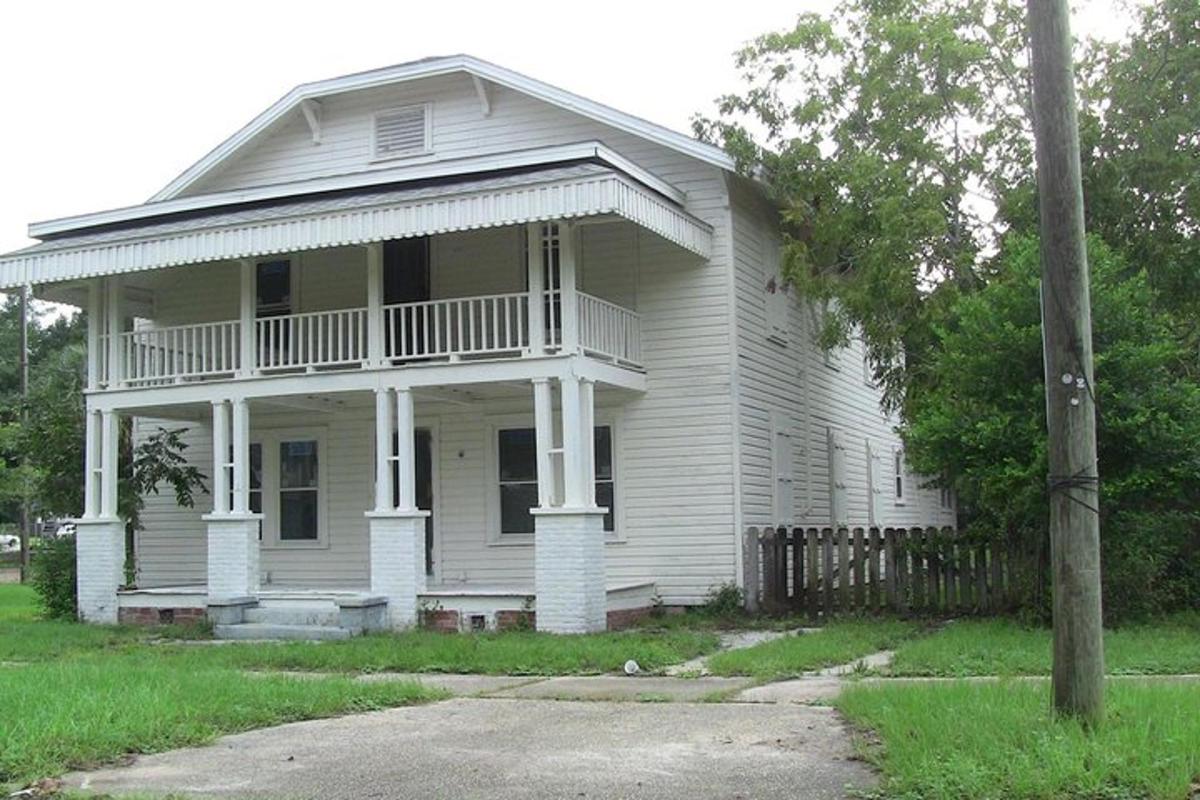 a white house with a porch and a balcony
