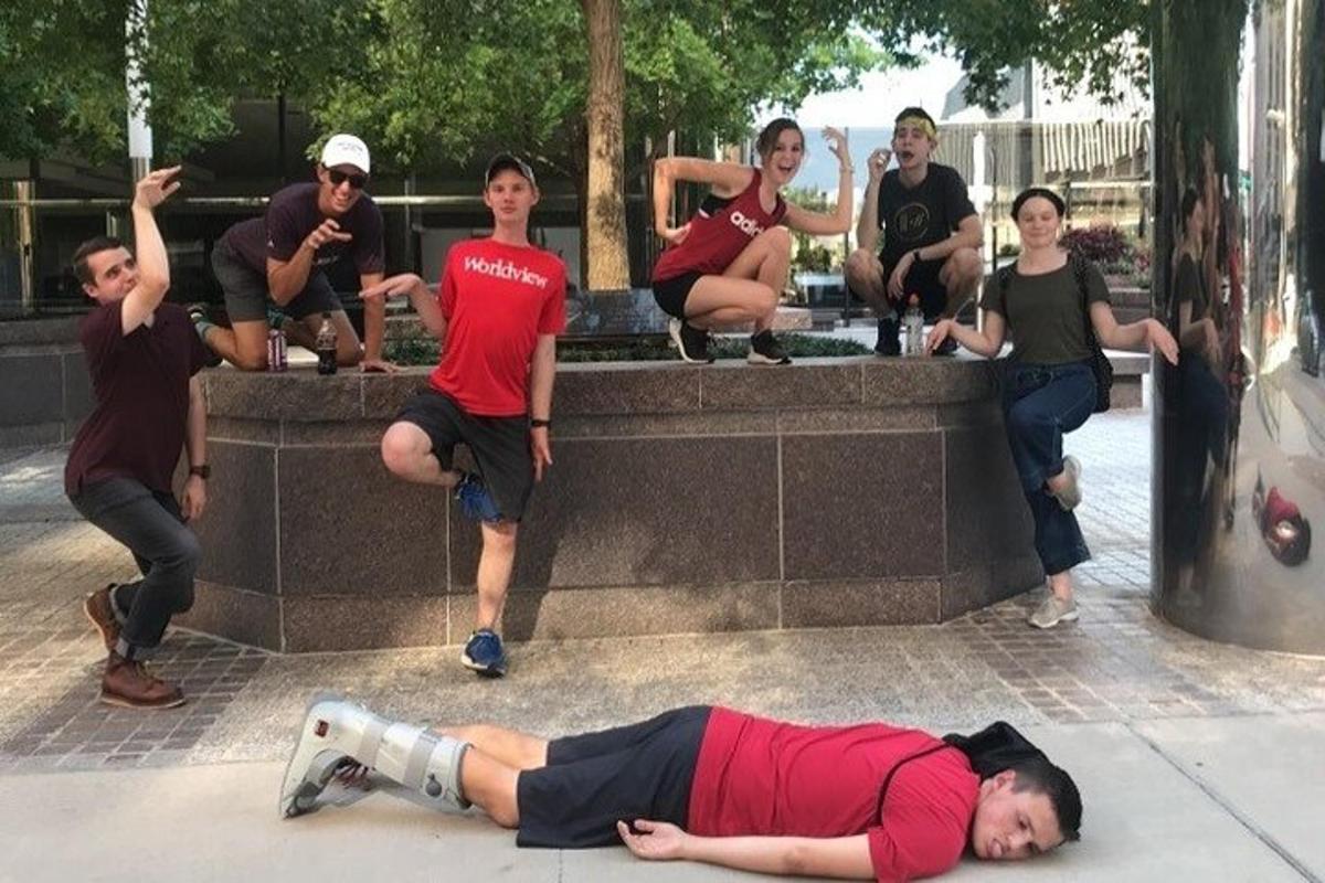 a man laying on the ground in front of a group of people